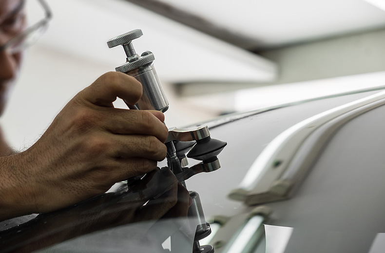 mechanic fixing damaged windscreen